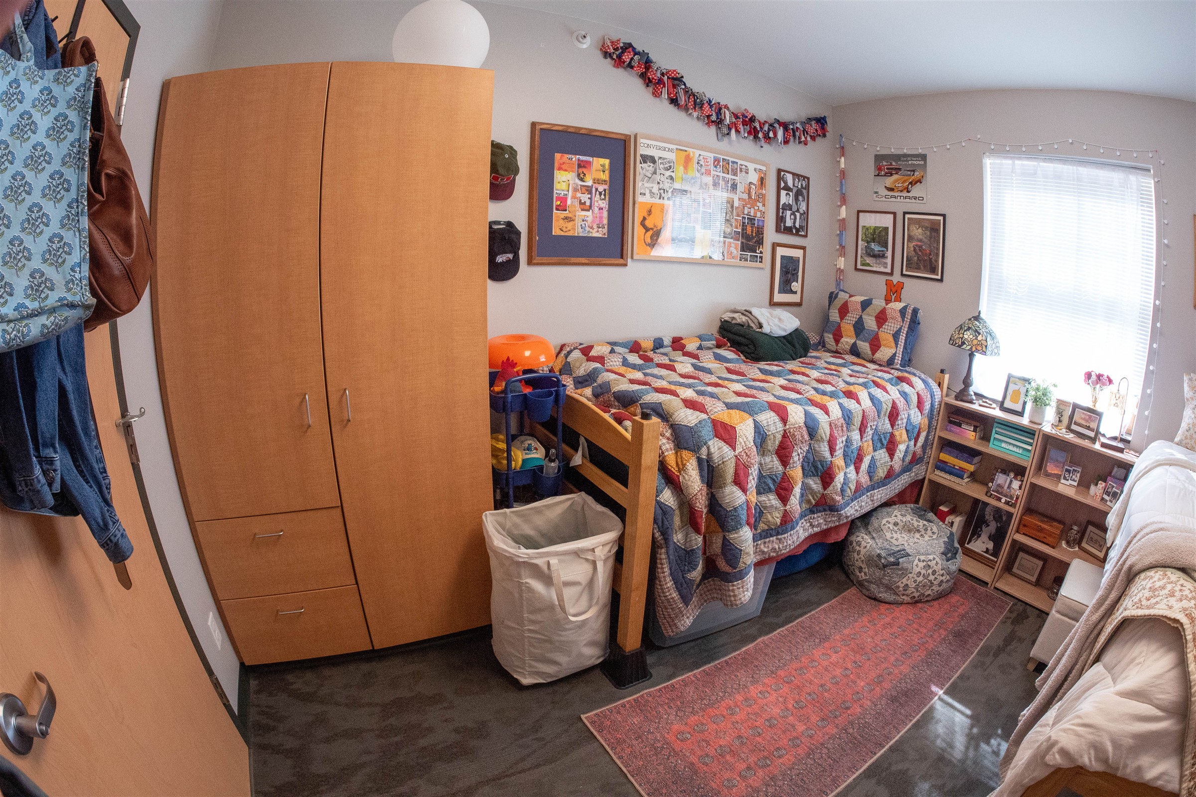 Interior of Richie Hall dorm room with plaid bed